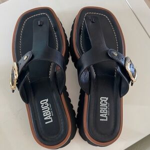 Labucq Black Leather Toe-Post Sandals with Brown Trim and Gold Buckles